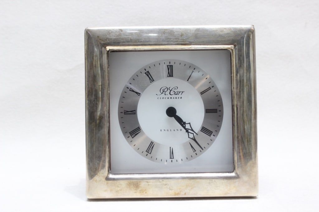 vintage sterling silver-framed desk clock: Dimension: 12cm x12cm Maker's Mark (RC): The letters in a hexagonal shield stand for Carrs of Sheffield Ltd, founded by Ron Carr in 1976. Purity Mark (Lion Passant): The walking lion