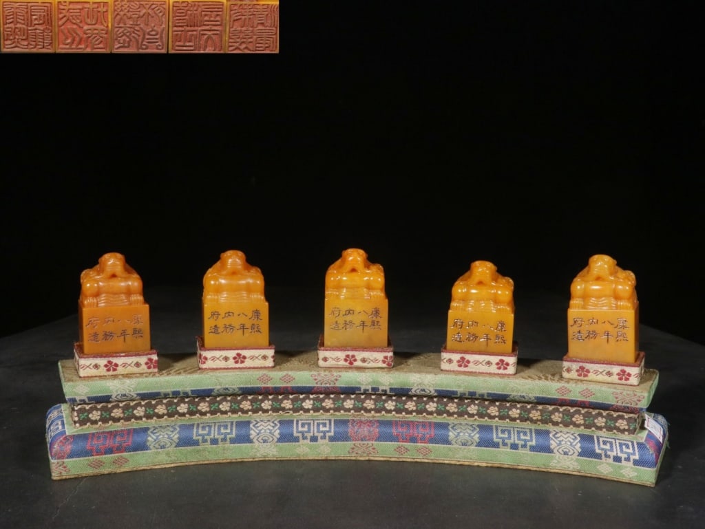 Five Chinese Yellow Soapstone Seals Set: Dimension: 5.1/5.3/5.3/5.4/5.5cm H, 3.2/3.4cm L,3.2/3.4cm w,the weight is 584.1gram. Each seal is surmounted by a hand-carved auspicious beast (typically a Pixiu or a dragon) and features