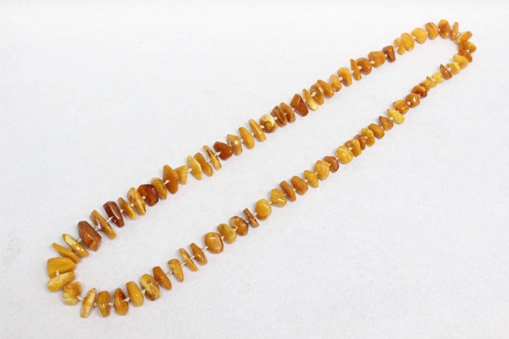 butterscotch Baltic amber nugget strand Necklace: The strand consists of polished nuggets or chips rather than uniform spheres. These pieces are often graduated, with larger nuggets positioned at the center. 15"L