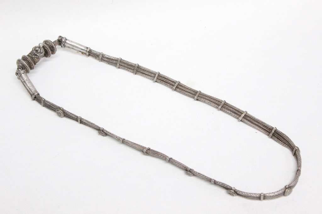 Antique High-grade Silver Tribal Belt: Dimension: 223gram. The belt/necklace features distinctive, multi-strand woven or braided silver wire that forms flexible links. These segments are connected by intricate cylindrical or