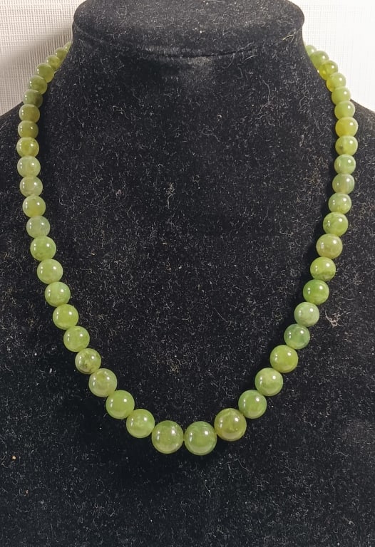A Green Jadeite Beads Necklace: A Green Jadeite Beads Necklace . L : 21 " Bead LARGEST : 12 mm. W : 60 G