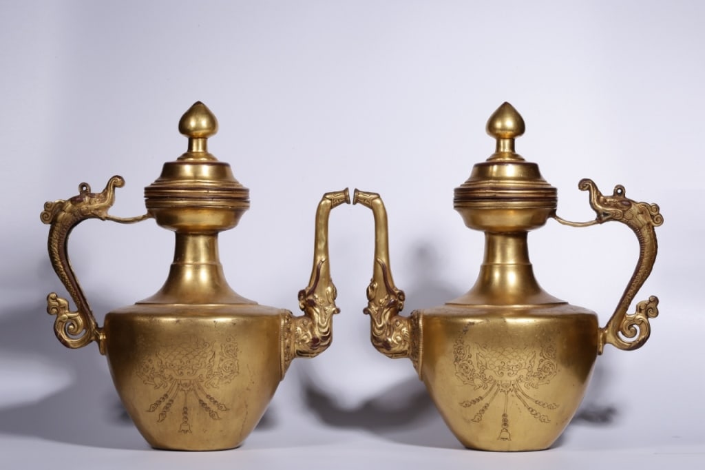 Pair of Sino-Tibetan Gilt-bronze dragon-handled Ew: Sino-Tibetan Gilt-bronze dragon-handled Ewer. Dimension: 33cm H x 29 x 19cm,weight is 2909gram ,2692gram These vessels are characterized by their elaborate