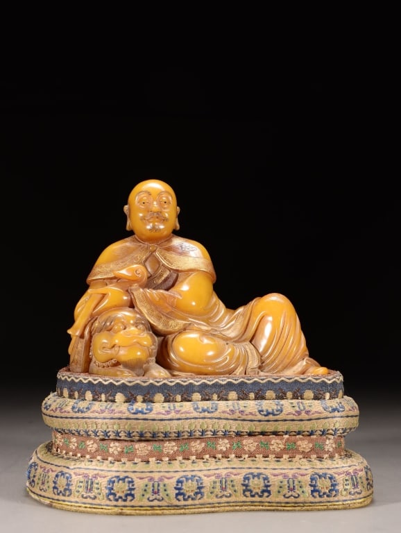 Finely Carved Shoushan Stone Figure of a Luohan: Dimension: 8.8cm H x11cm Lx x 7.3,weight is 432gram. The figure is a Luohan, one of the legendary enlightened disciples of the Buddha. He is accompanied by a recumbent lion, identifying him
