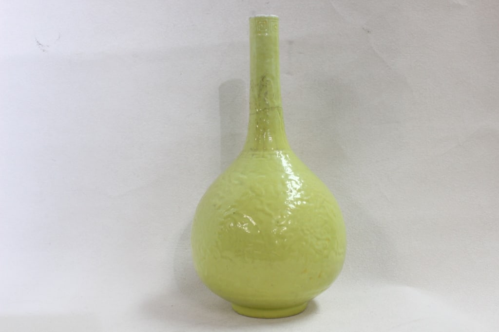 Chinese Lemon-yellow Monochrome"Tianqiuping"Vase: Dimension: 8 1/2" Underneath the glaze, you can see molded or incised (anhua) decoration. This likely depicts a writhing dragon chasing a flaming pearl amidst clouds, a classic imperial motif represen