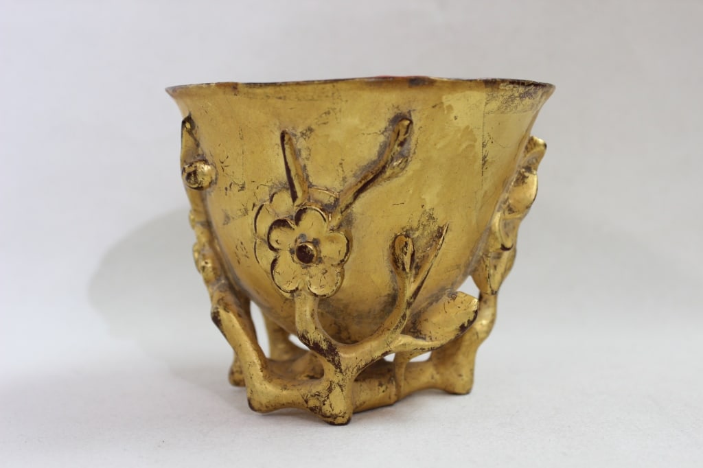 Chinese Gilt-Lacqure Wood Vessel: Dimension: 4 1/2"W x 3 1/2"H . It is characterized by its footed "flower-form" design and relief-cast floral and branch motifs