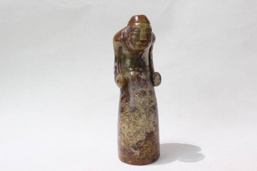 Chinese Jade Carved Figurine: Dimension:13cm L . It depicts a stylized human figure, sometimes identified as a dignitary or priest, with hands often joined at the waist or sides in a ritual pose.