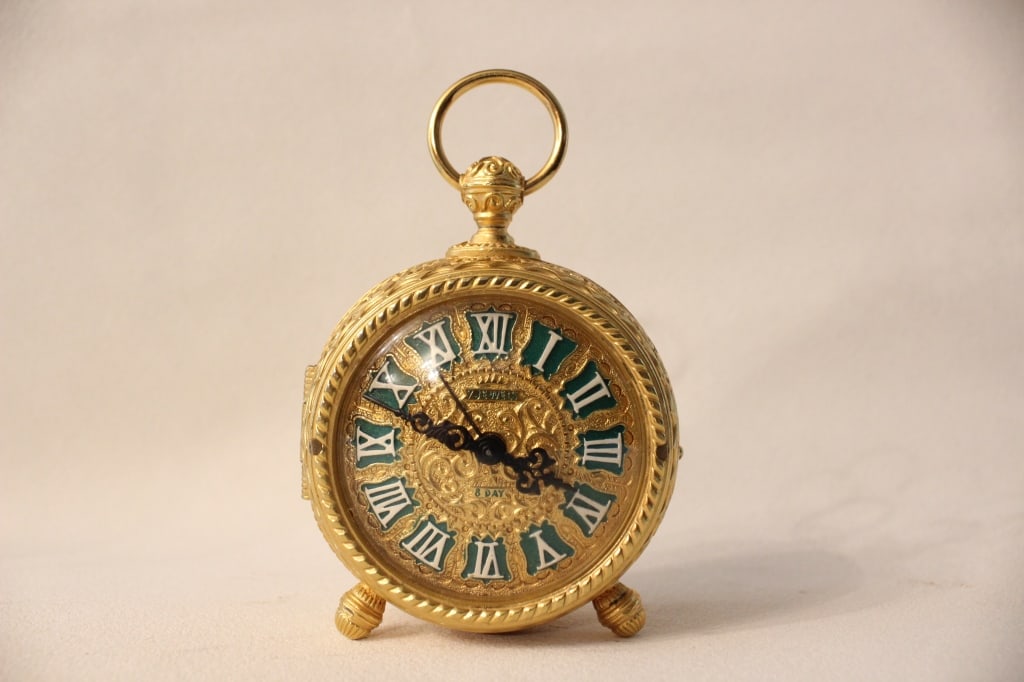 Vintage Schmid Du Chateau Clock ~ 7 Jewel 8 Days W: Vintage Schmid Du Chateau Clock ~ 7 Jewel 8 Days Wind Up with Alarm ~ Gold Tone Dimension : 3"W x 4 3/4"H. Working condition. The clock has a circular, gilt brass case richly accented with an ornate,