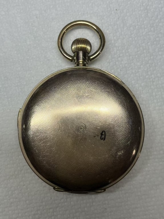 Antique Gold Filled Pocket Watch: This timepiece features a pristine white enamel porcelain dial utilizing classic, elongated black Roman numerals to indicate the hours. Engraved inside the front lid are the markings GOLD FILLED /