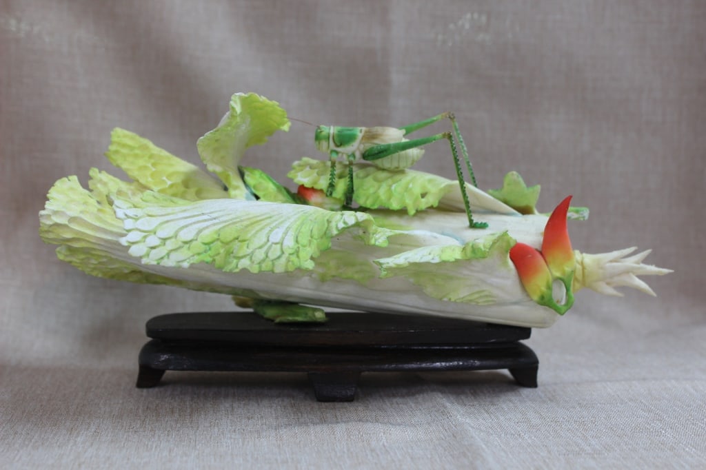 Chinese Polychrome Bone Carving of a cabbage with: Chinese polychrome ivory carving of a cabbage with a grasshopper. Dimension:8 1/2"L . : The sculpture captures the delicate textures of a Napa cabbage leaf (bok choy) complete with a