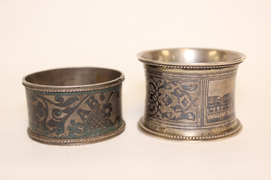 Antique Imperial Russian silver and niello napkin: antique Imperial Russian silver and niello napkin ring. One features a panoramic architectural rendering of the Moscow Kremlin skyline, depicting the historic fortress walls, brick towers, and