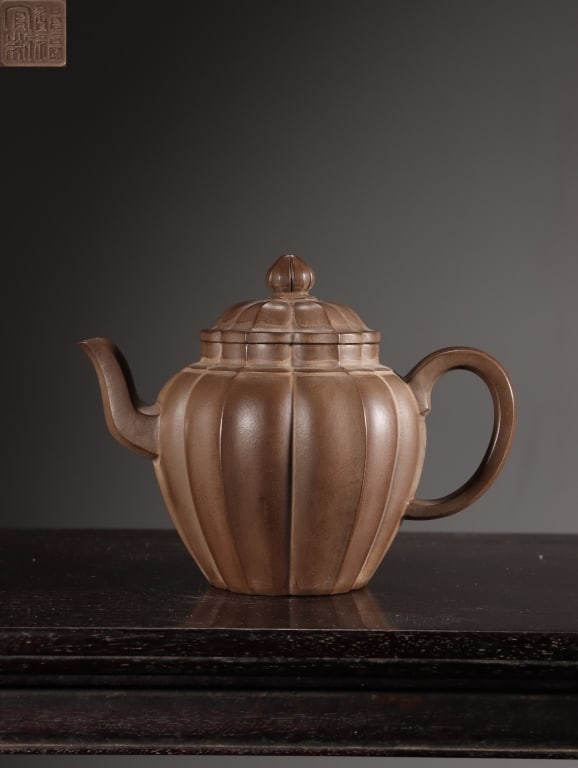 Chinese Yixing Zisha (purple clay) Teapot,Mark: The removable lid is topped by a finial sculpted in the shape of a tightly closed lotus or mallow bud, echoing the overall organic floral theme of the teapot. Dimension : 10.3cm H x 13.5 x 7.5cm,weigh