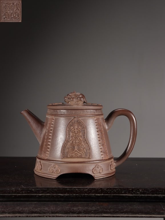Chinese Yixing Zisha (purple clay) Teapot: Dimension : 10.6cm H x 15.5 x10.3cm,weight is 356gram. The main body mimics a truncated cone shape, strongly resembling a traditional Chinese bronze bell (Zhong). It is supported by an integrated,