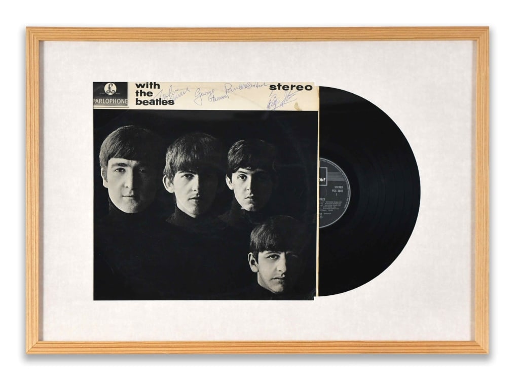 THE BEATLES?Fully Signed With the Beatles(Parlopho: The sleeve is mounted to the left, displaying the iconic Robert Freeman portrait?one of the most recognizable images in popular music history?while the vinyl record is presented to the right in a bala
