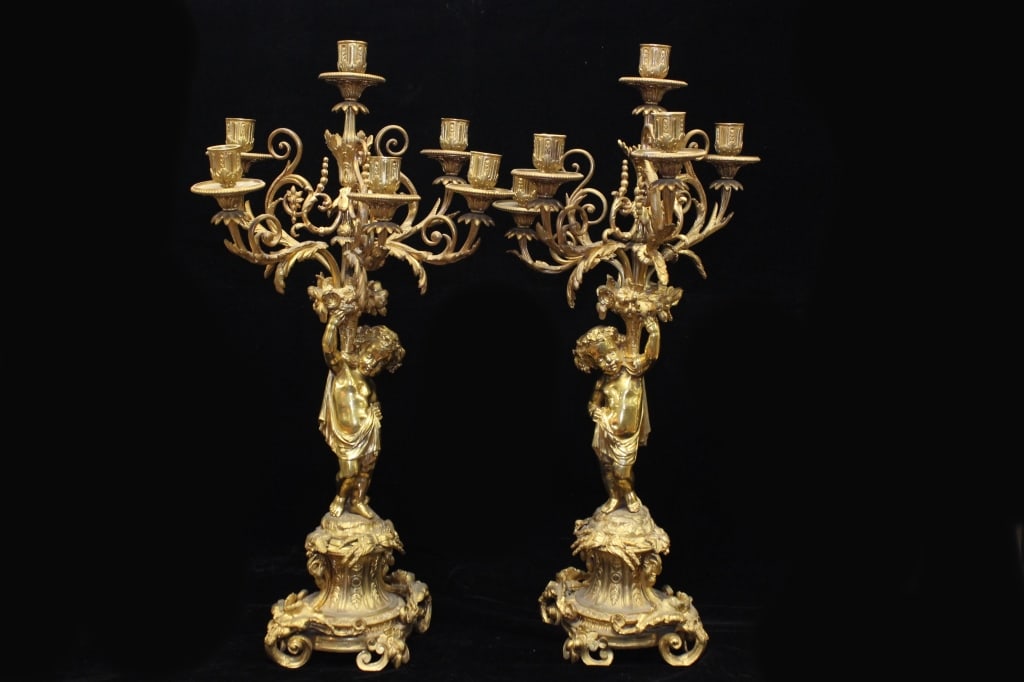 19th.C French Gilt Bronze Figural Candelabra,Pair: Dimension: 25"inch H. Each candelabra features a central putti (cherub) figure supporting a multi-arm structure. The arms are intricately modeled with floral and acanthus leaf motifs, common in Neocla