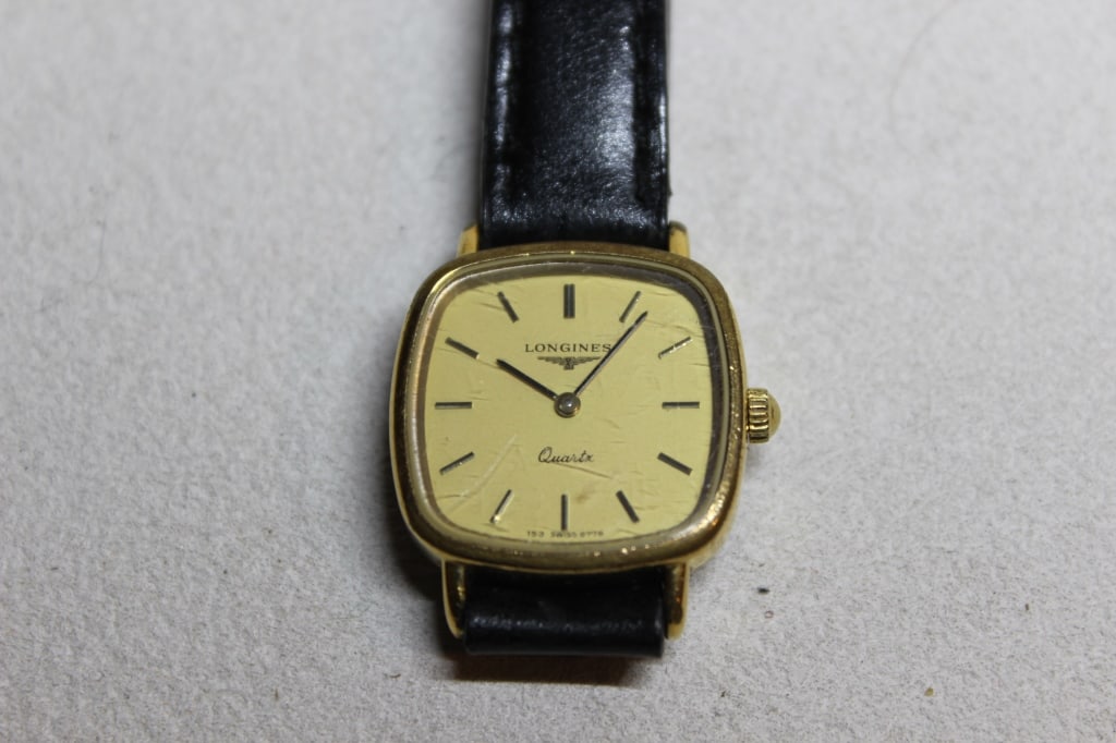 Vintage Longines Presence quartz watch: The watch has a small, gold-plated cushion-shaped case (often referred to as a "TV" or "cushion" case).It is powered by a high-quality Swiss quartz movement. The face features a brushed champagne or