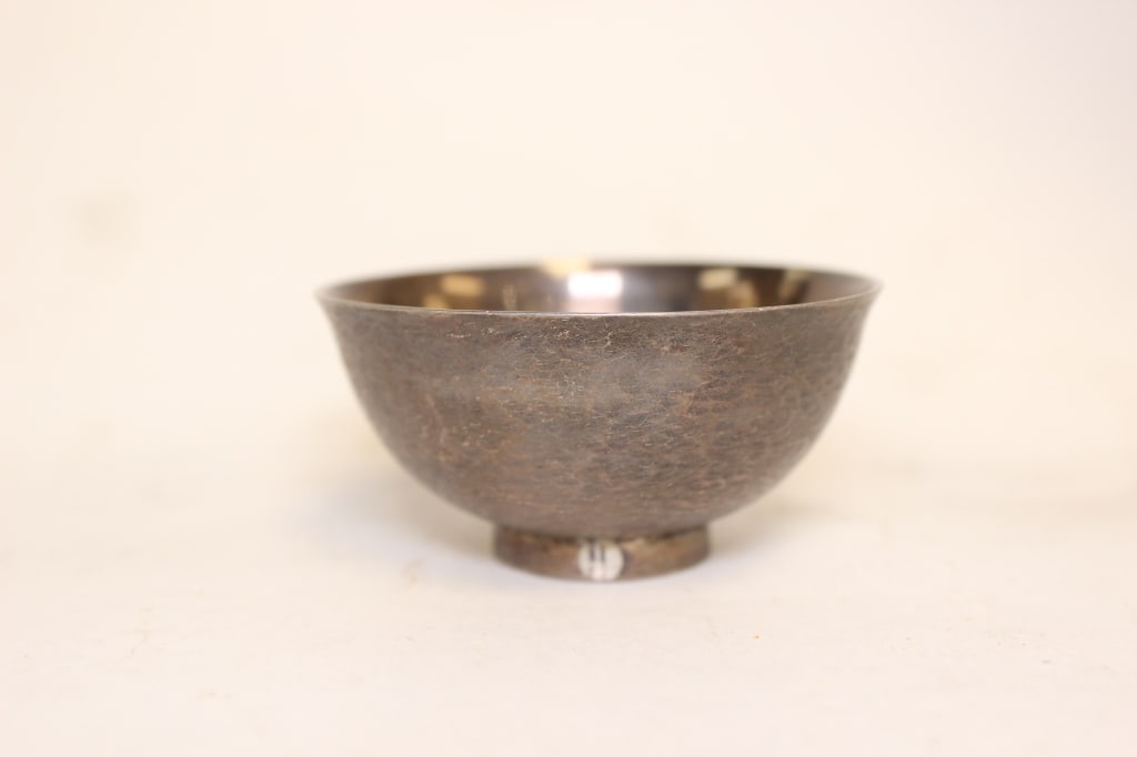 Japanese silver footed Sake Bowl.Mark .: Dimension : 2 1/2"W. The rectangular cartouche stamped on the side of the bowl reads ???? (Mitsukoshi). the circular foot features a beautifully turned concentric spiral pattern, which reflects a