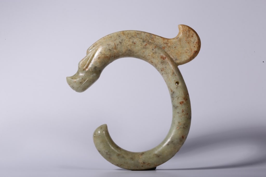 Chinese Archaic Jade C-shaped Dragon: Dimension : 20.5cm L x 20cm x2.8cm,weight is 880gram. The artifact features a distinct, tightly curved C-shaped silhouette sculpted from a single piece of stone. The body is sleek, rounded, and tapers
