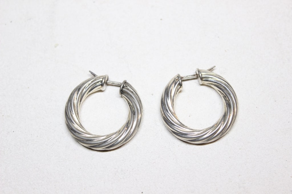 vintage sterling silver twisted hoop earrings: vintage sterling silver twisted hoop earrings, likely of Italian origin. The design features a chunky, "rope" or "cable" twist pattern, which was a popular style in mid-to-late 20th-century jewelry.
