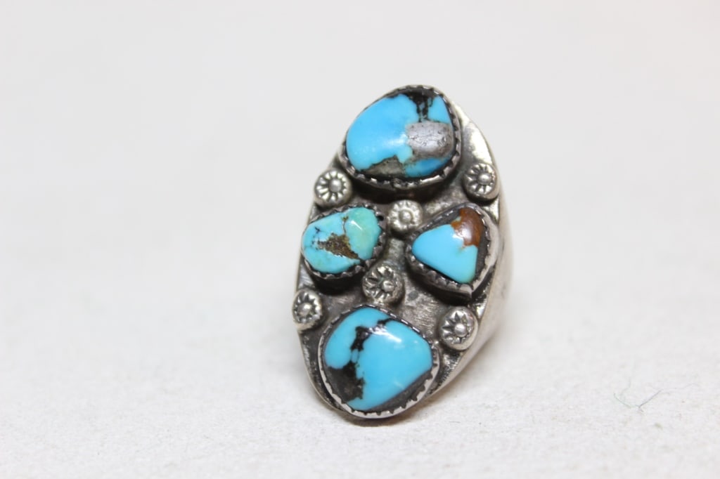 Vintage Navajo Turquoise cluster Ring: vintage Navajo turquoise cluster ring, likely dating from the third quarter of the 20th century. The ring features four distinct turquoise nuggets with a prominent dark brown or black matrix. The