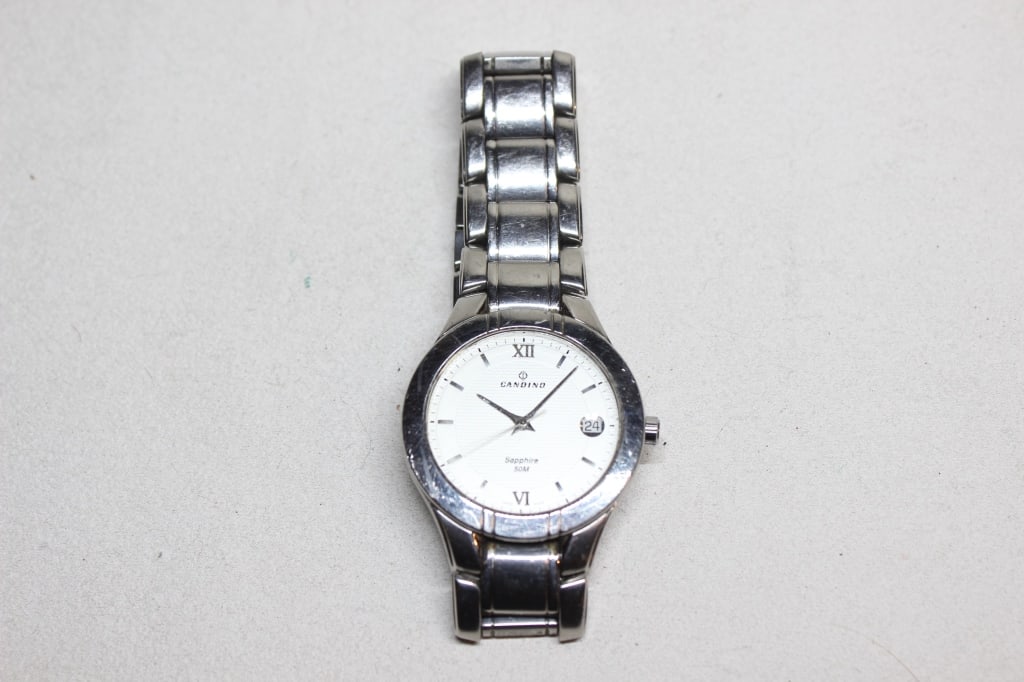 Candino Swiss Made wristwatch: Candino Swiss Made wristwatch, a brand founded in 1947 in Herbetswil, Switzerland, and now part of the Festina Group. Based on its design and markings, it is likely a mid-size or ladies' model from