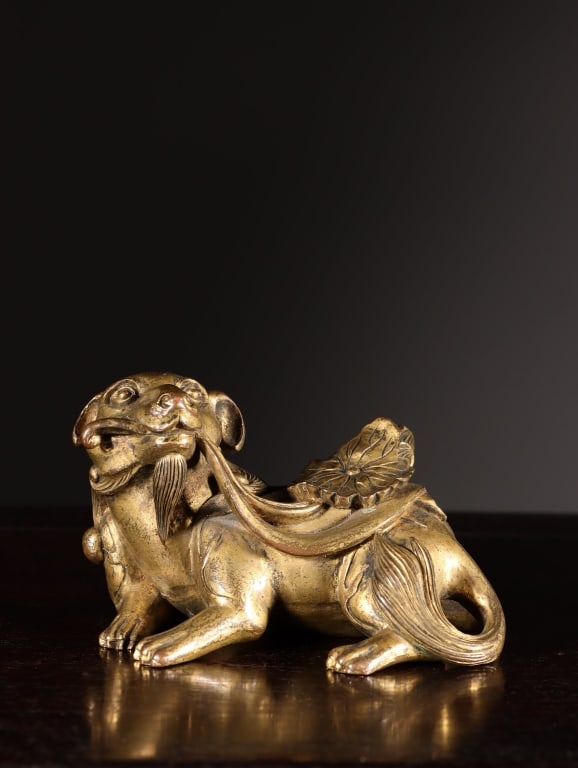 Chinese gilt-bronze figure of a mythical Pixiu: Dimension : 5.3cm H x 9cm L x 5.5cm,weight 633gram. The creature is modeled as a crouching mythical guardian beast. It features prominent bulbous eyes, a stylized ruyi-shaped nose, floppy ears,