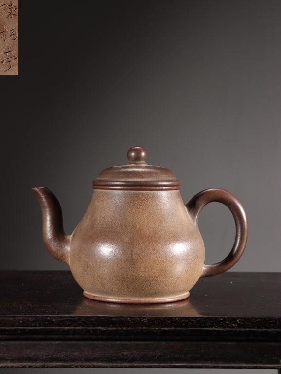 Chinese Yixing Zisha (purple clay)Pear-shapeTeapot: Dimension : 11.3cm H x 16cm x 9.5cm,weight is 302gram. It features a broad, heavy lower belly that tapers upward into a high neck, topped by a neatly domed lid and a simple, circular button finial