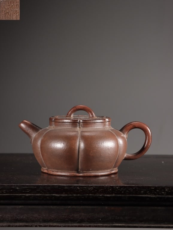 Chinese Yixing Zisha (purple clay) Teapot,Mark: Dimension : 6.3cm Hx 12cm x 8cm,weight is 134gram. The main body is sculpted into a classic lobed or segmented pumpkin/melon shape (kuawen style), partitioned into multiple symmetrical vertical rib