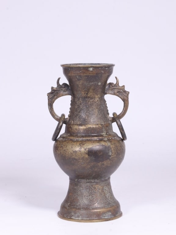 Chinese bronze two-handled ritual vase: Chinese bronze two-handled ritual vase Dimension : 20cm H x 10cm. weight is 1287gram. This vessel conforms to the traditional Hu (?) profile, featuring a flared trumpet mouth, a cinched neck, a