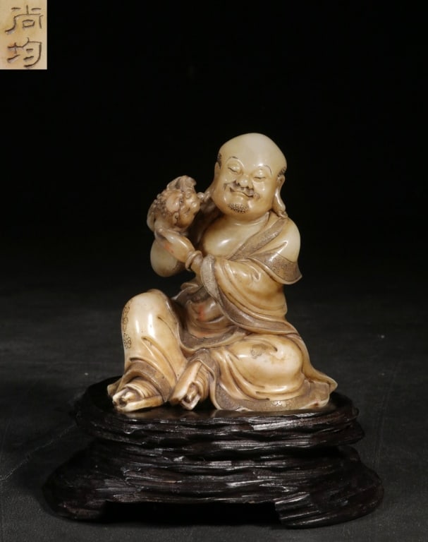 finely carved Chinese Shoushan Furong stone sculpt: finely carved Chinese Shoushan Furong stone sculpture depicting a Luohan playing with a lion, bearing the signature mark of the legendary master carver Zhou Shangjun. Dimension : 13.5cm overall Heigh,