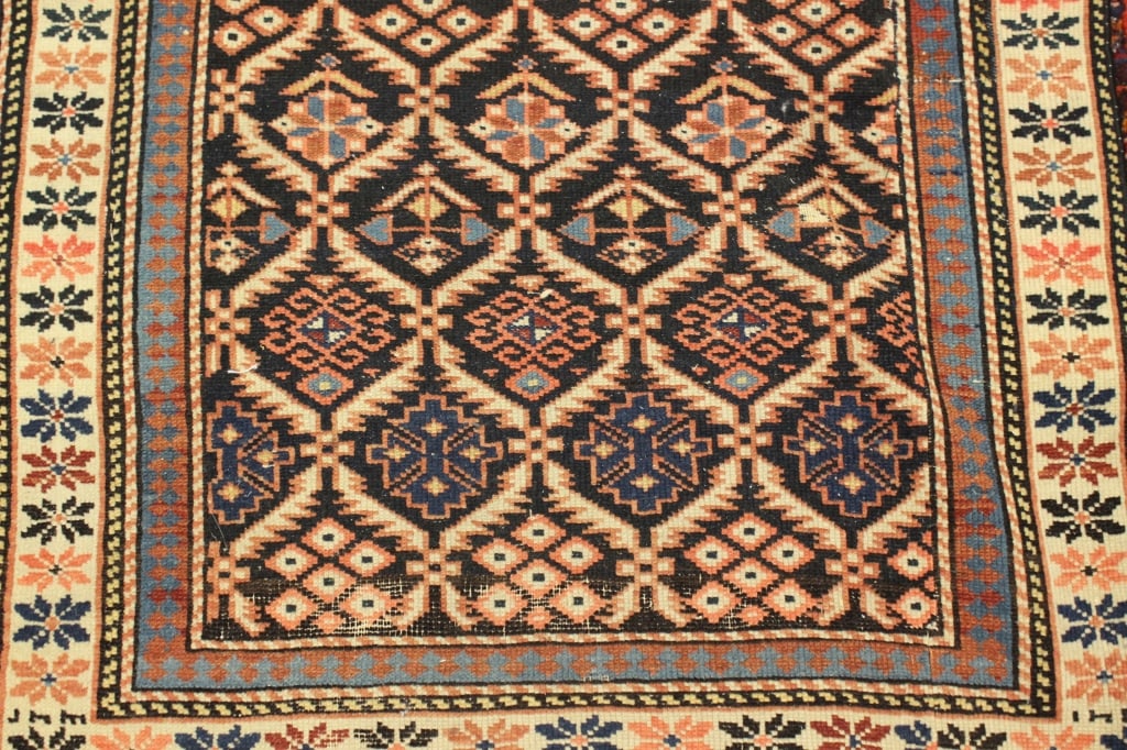 finely hand-knotted antique Caucasian Shirvan rug: Dimension:28"x 42" a finely hand-knotted antique Caucasian Shirvan rug, highly characteristic of tribal weaving traditions from the Eastern Caucasus region. The central field features a striking navy 