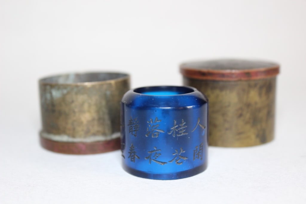 Chinese Peking glass archer's ring: Dimension: 4cm x 4.5cm . The ring is crafted from Peking glass (?? Liaoqi), displaying a brilliant, translucent cobalt blue color. Peking glass was highly favored during the Qing Dynasty as an afforda
