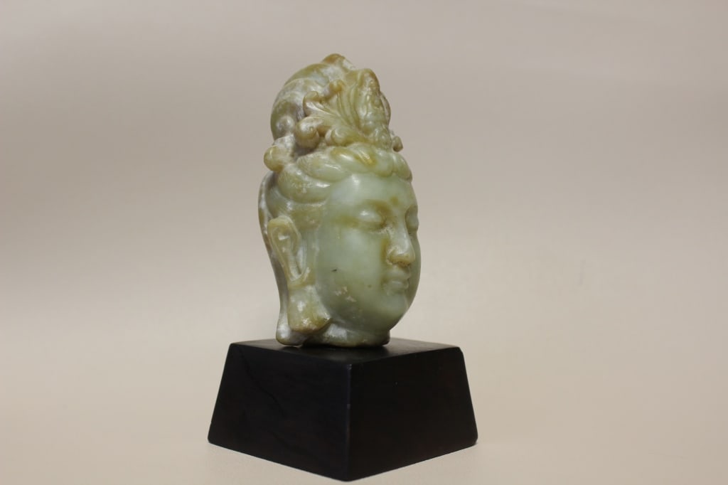 Chinese Jade Head Sculpture of Guanyin: Dimension:3 1/2"H. The facial features reflect classic Buddhist aesthetics, showing a peaceful expression with downcast slit eyes for meditation, a delicate nose, and a gentle smile.