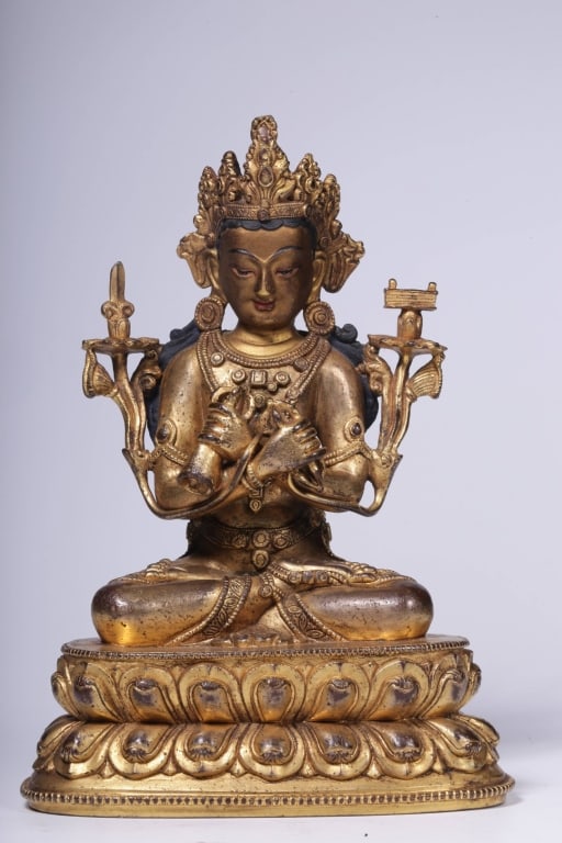 Sino-Tibetan gilt-bronze figure of Manjushri,: Sino-Tibetan gilt-bronze figure of Manjushri, Dimension: 16cm H x 11.5cm L x7.7cm W,weight is 842gram. His hands are held before his chest in the dharmachakra mudra, symbolizing the turning of the