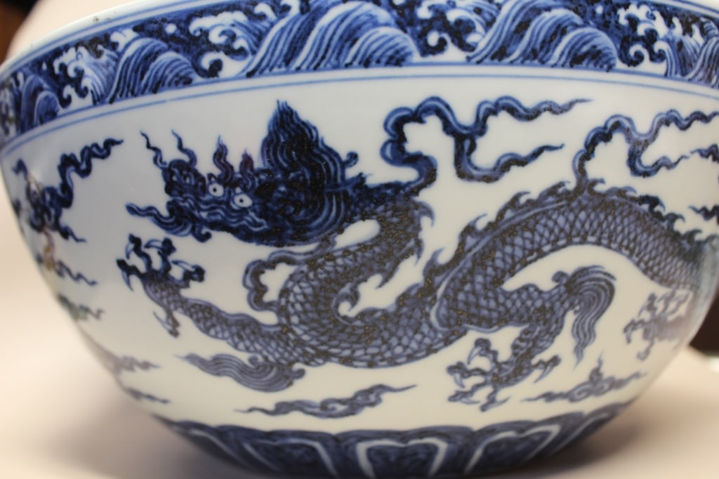 Chinese Blue and White Porcelain Bowl: Chinese Blue and White Porcelain BowlDimension:10 1/2"W. A powerful underglaze-blue five-clawed imperial dragon soaring through ruyi-shaped clouds. A continuous band of cresting, turbulent sea waves o
