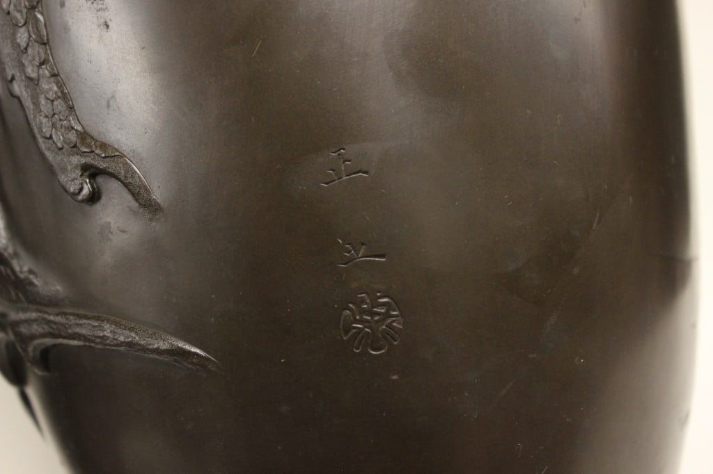 antique Japanese bronze ovoid vase,Signed: Dimension:15 1/2"H. antique Japanese bronze ovoid vase, featuring detailed high-relief work. The surface is finished with a dark, rich brown patina that highlights the textures of the decoration.The b