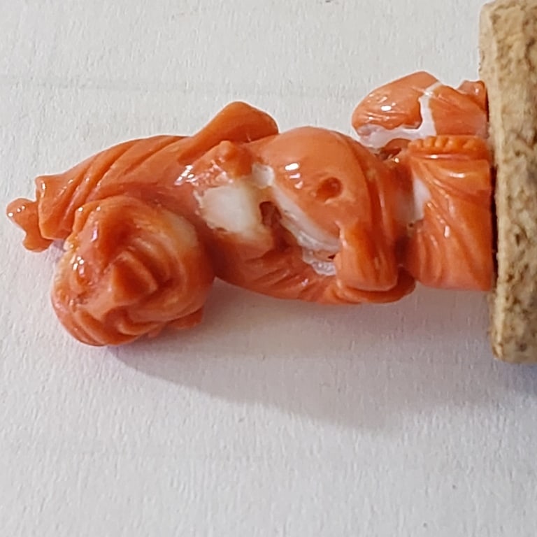 RED CORAL CARVING MAITREYA BUDDHA.: RED CORAL CARVING MAITREYA BUDDHA. The carving depicts Budai (??), a historical Chinese Zen monk revered in folk Buddhism as an incarnation of Maitreya (the Future Buddha). He is shown standing with o