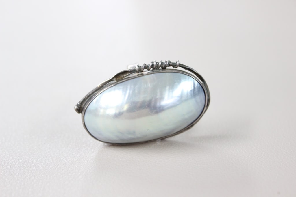 Bohemian-style Statement Sterling Silver Ring: large, bohemian-style statement ring featuring an oval mother of pearl (MOP) or a cultured Mabe pearl set in an artisan sterling silver setting. The ring showcases a large, oval-shaped cabochon stone 