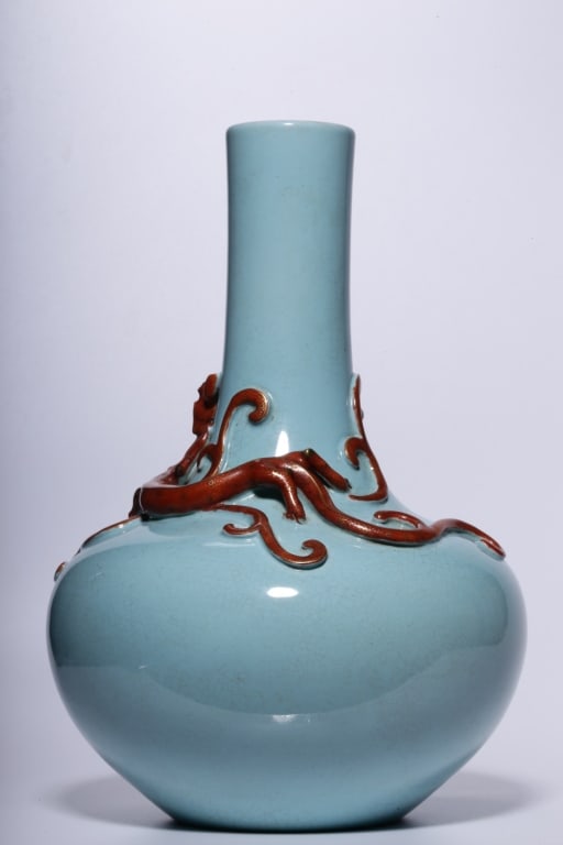 Chinese monochrome sky-blue glazed bottle vase: Dimension: 22.8cm H x 15 x7.1cm. Chinese monochrome sky-blue glazed bottle vase. Coiled dramatically around the long neck and spilling onto the shoulder is a high-relief, hand-sculpted chilong dragon 