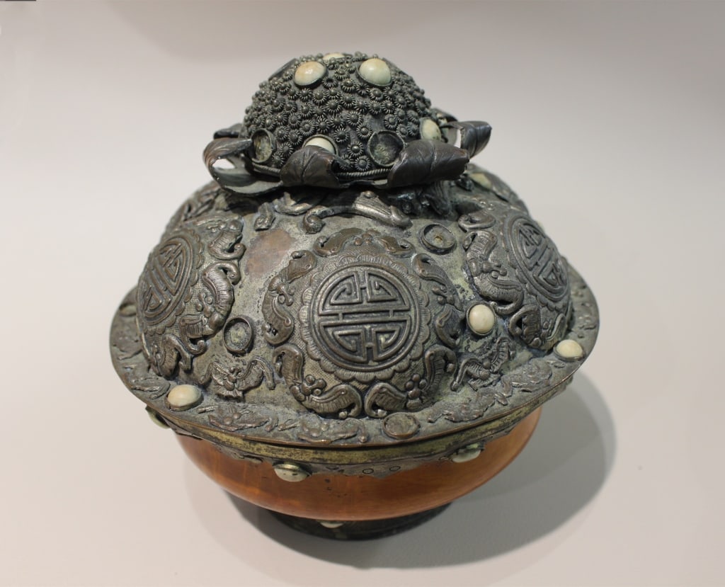 Asian Ceremonial or Ritual Container: Dimension:9 1/2"W The circular patterns on the lid are traditional Chinese Shou (?) symbols, which represent longevity. These are often used in auspicious art and ceremonial objects.Top Detail: The do