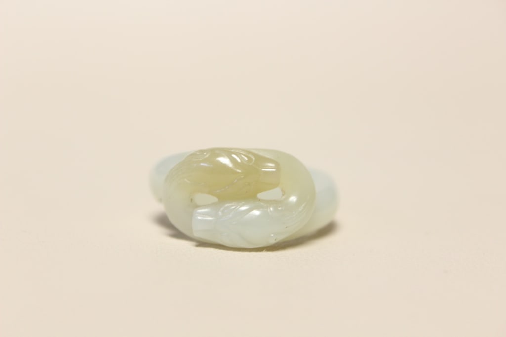 Chinese Hand-carved Jade Ring: Dimension:1 1/8"W. The carving depicts a coiled dragon (chilong) chasing or biting its own tail, forming a smooth, continuous ring structure.