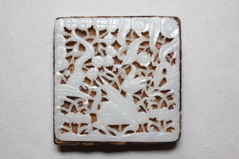 Chinese Ming Openwork White Jade Plaque w Amber: Chinese openwork white jade plaque. Dimension: 2 3/4"W. The lower-central portion features a stylized, long-necked mythical creature. Based on the winged form, sleek profile, and crested head, it