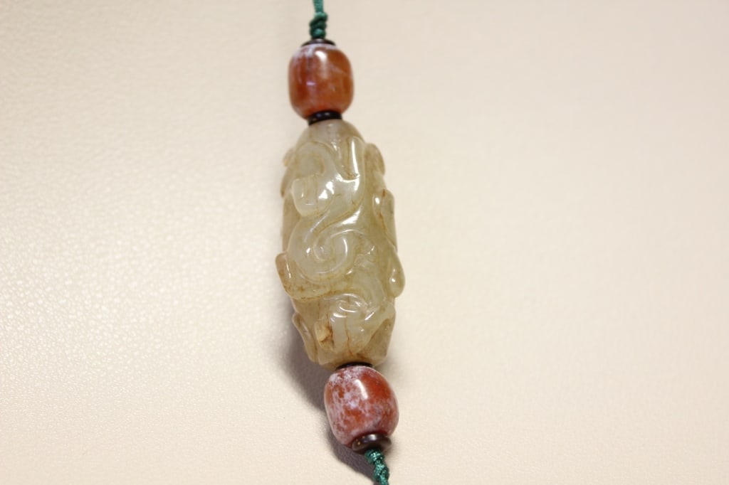 Chinese Jade Pendant Lezi Tubular amulet bead.: a cylindrical, hollowed jade bead carved from a nephrite jade. Dimension:1 1/2"L.