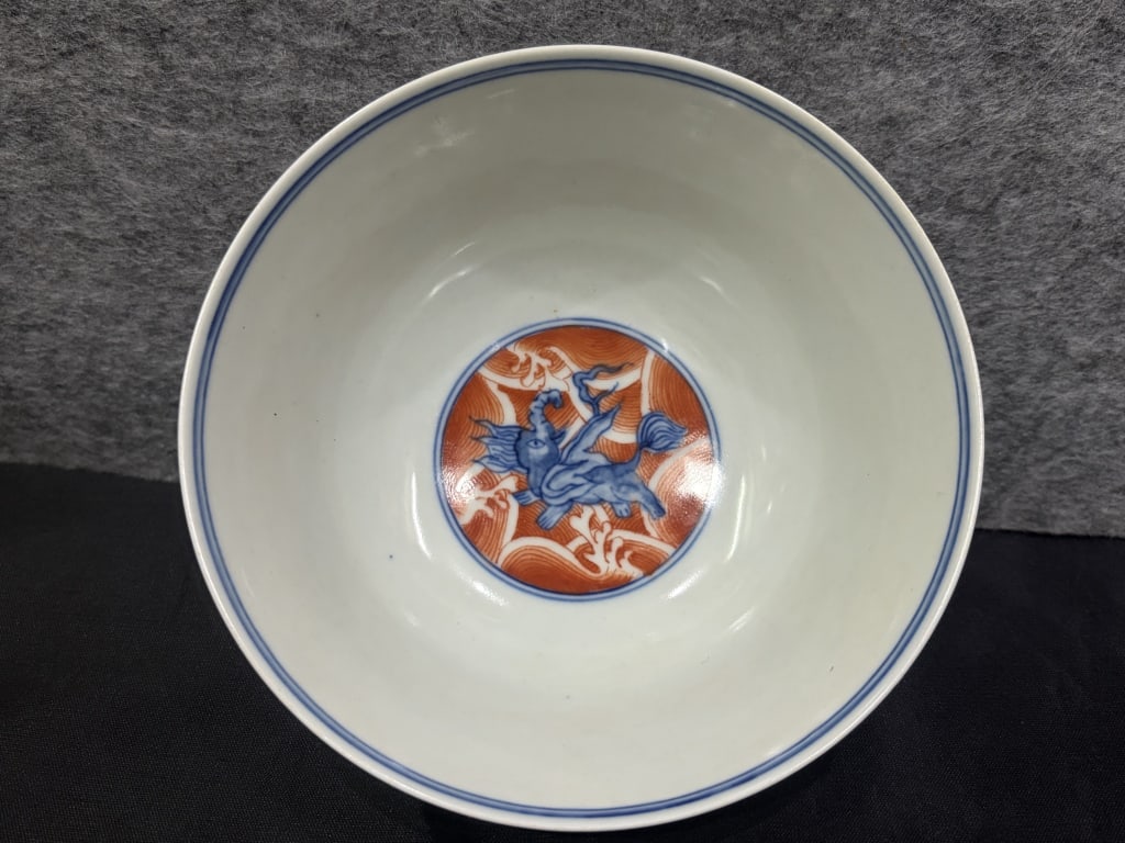 Chinese iron-red and underglaze blue porcelain bow: Chinese iron-red and underglaze blue porcelain bowl,mark. Dimension: 12.8cm w x 6cm H. The vessel is crafted with deep flaring walls rising from a defined, unglazed foot ring. The