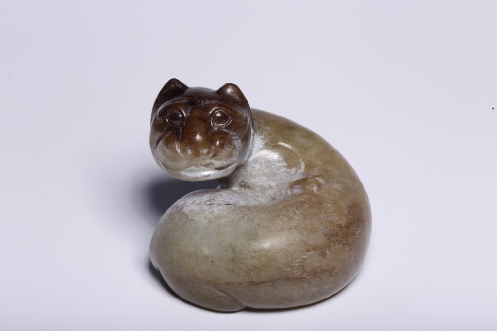 Chinese archaistic carved jade of a coiled mythic: Chinese archaistic carved jade figure of a coiled mythical beast Dimension: 5.3cm L x 4.3cm H,weight is 148.5g The animal is rendered in a tight, fluidly coiled