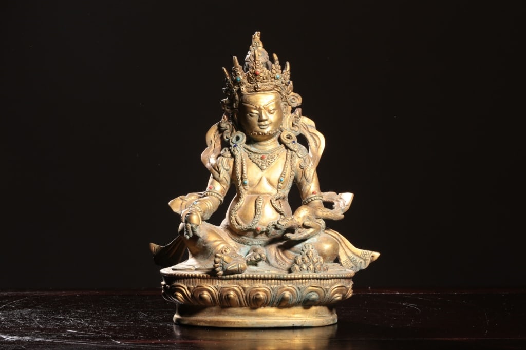 Chinese gilt bronze statue of Dzambhala: the prominent Buddhist deity of wealth, fortune, and generosity. Dimension: 22.8cm H x 18.5 x 10.7cm,weight is 1886.6gram. The figure is depicted with characteristic