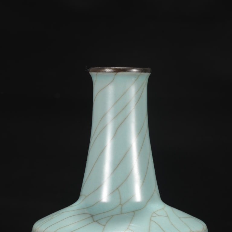 Chinese monochrome celadon-glazed mallet vase: Chinese monochrome celadon-glazed mallet vase Dimension: 23.5cm H x 13.5cm w . The vessel features a straight cylindrical body with a crisp, angled shoulder that tapers upward into a long, slender nec