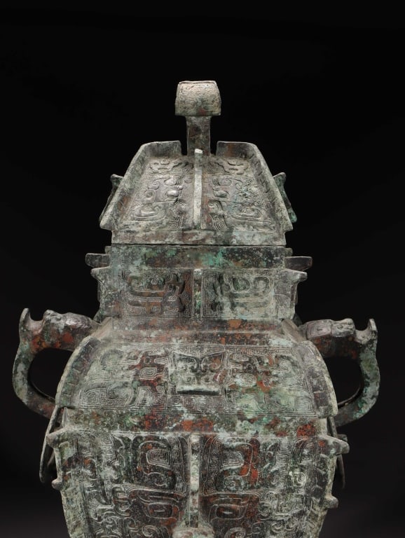 Chinese ritual bronze wine container(fanglei ): Dimension: 47cm H x 30x 22cm,weight is 10.25kg The vessel features a massive, rectangular baluster body tapering down to a stepped, hollow foot,epitomizing the complex geometry of early Chinese ritual