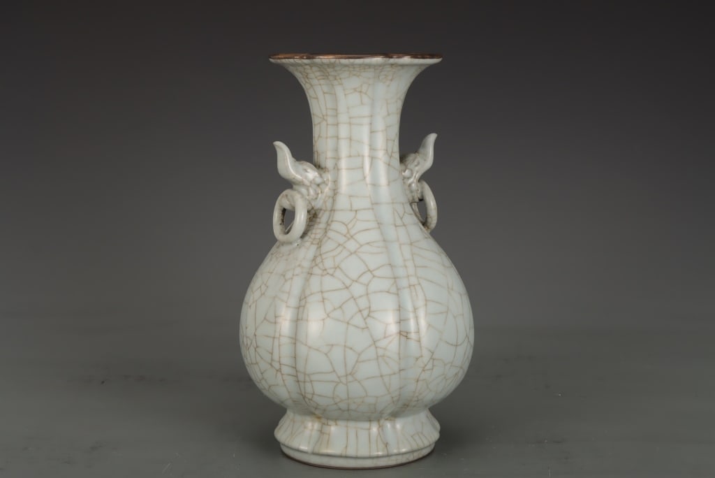 Chinese crackle-glazed lobed vase: Dimension: 27 H x 17cm w. The vessel is crafted with a pear-shaped (yuhuchunping) body molded with vertical lobes that mimic a melon or flower blossom. It rises to a tall, flared neck flanked by two s