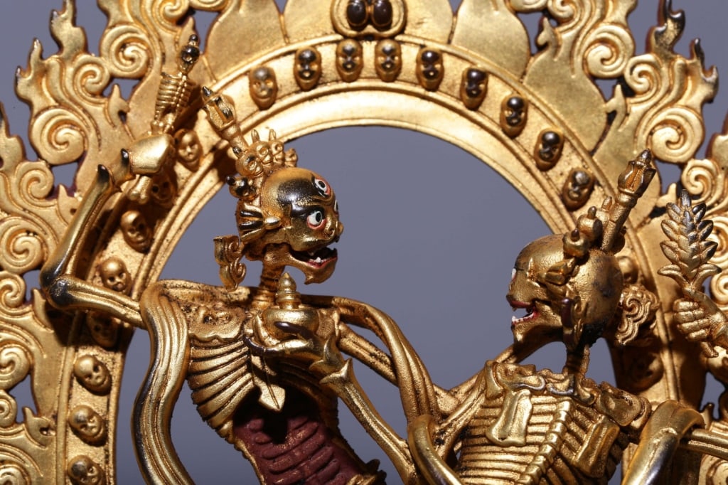 Sino-Tibetan gilt bronze figure of the Citipati: Sino-Tibetan gilt bronze figure of the Citipati. Dimension: The piece depicts a male and female skeleton couple performing a cosmic dance of liberation. Both figures display three-eyed