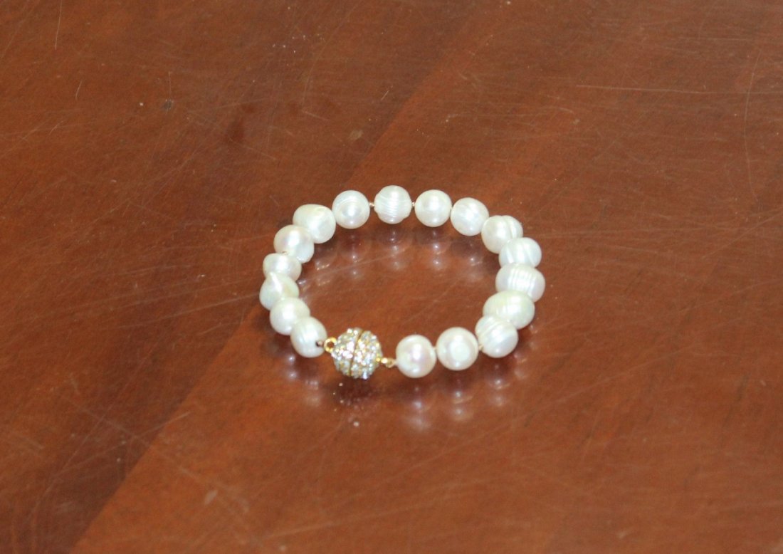 Natural Fresh Water White Pearl Bracelet: Beautiful natural fresh water pearl bracelet with 12 mm pearls and a round rhinestone clasp. The interior length is 7 1/2". It is in very good condition.